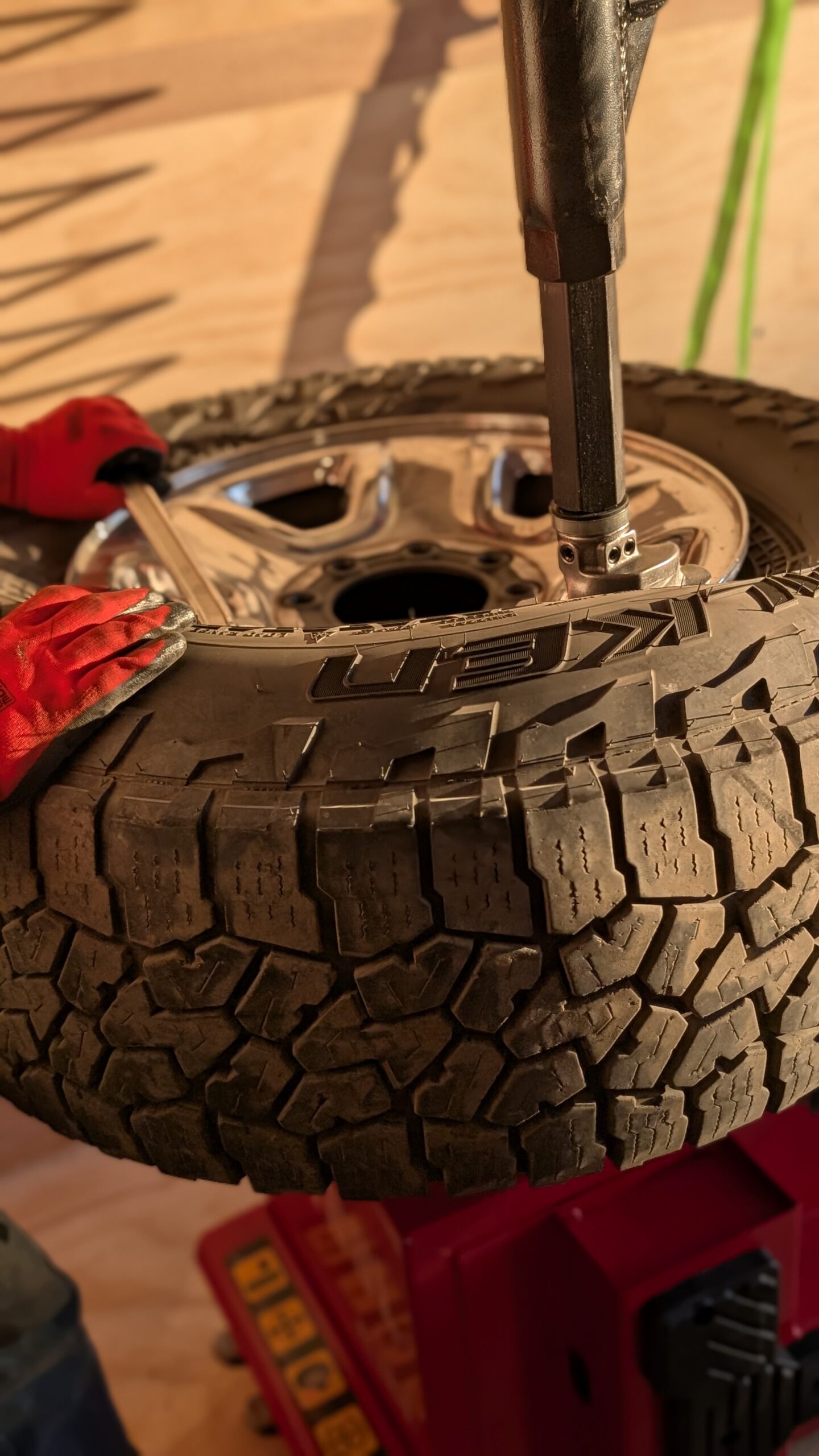 Premier Mobile Tires technician installing a tire on site